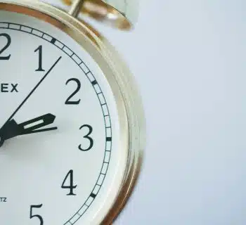 round Timex analog clock at 2:33