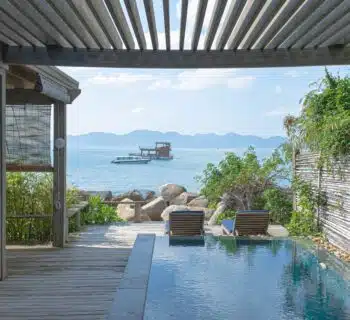 brown wooden chairs near swimming pool during daytime