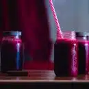 red beverage in mason jars