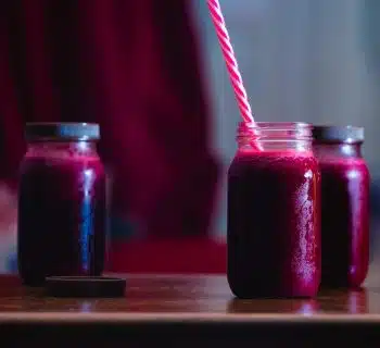 red beverage in mason jars