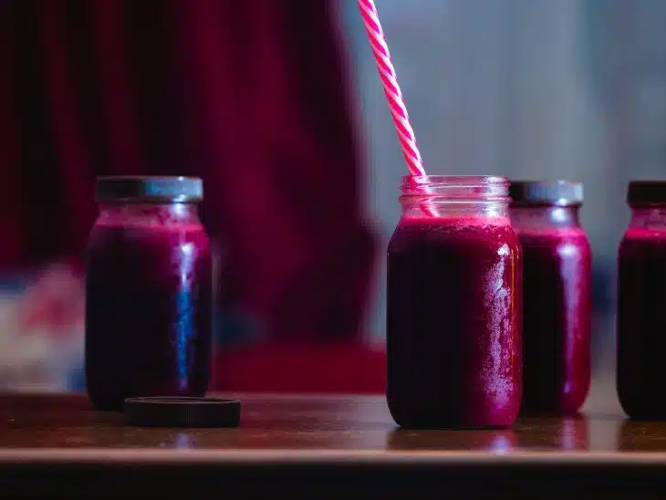 red beverage in mason jars
